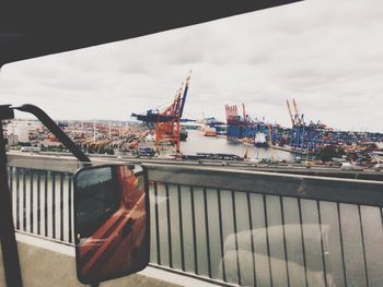 Close-up of harbor against sky in city