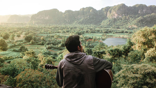 Rear view of man looking at mountains