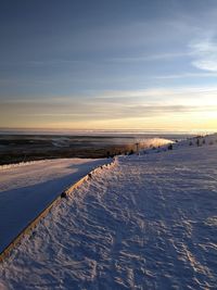 Scenic view of frozen lake against sky during winter