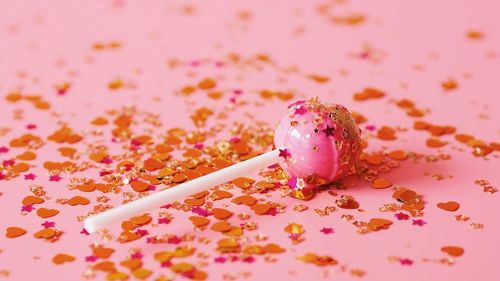 Close-up of candy over pink background