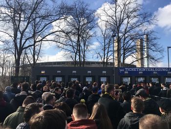 Group of people in city against sky