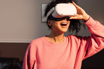 Smiling woman using virtual reality simulator