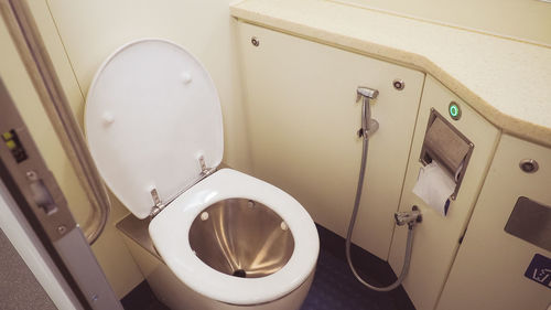 High angle view of toilet bowl in public restroom