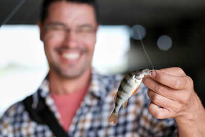 Happy fisher shows catch