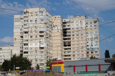 Low angle view of destroyed buildings against sky