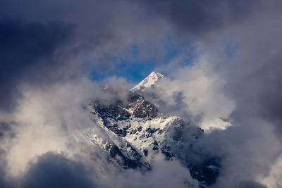 Low angle view of snowcapped mountain against sky