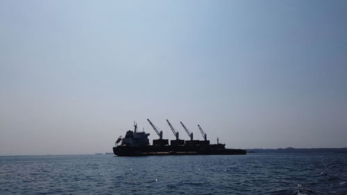 Ship in sea against clear sky