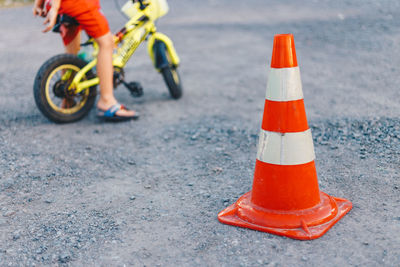 Low section of person with umbrella on road