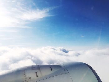 Low angle view of airplane wing against sky