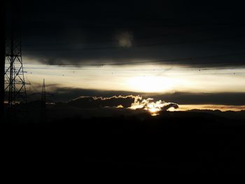 Silhouette landscape against sky during sunset