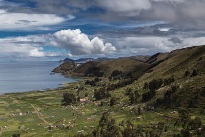 Scenic view of sea and mountains against sky