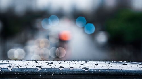 Close-up of raindrops on car windshield during rainy season