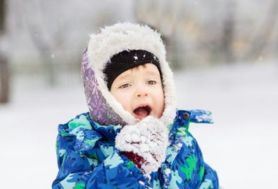 Close-up of cute boy looking away during winter