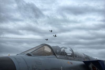 Low angle view of airplane flying against sky