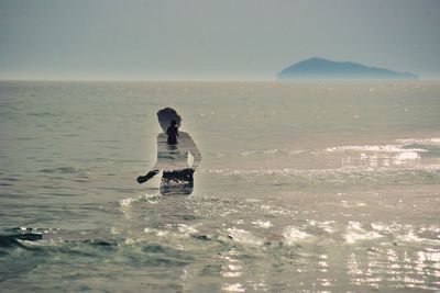 Multiple exposure image of woman in sea