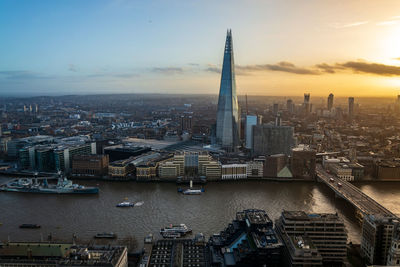 Aerial view of buildings in city during sunset