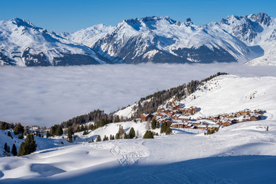 Plagne soleil ski resort in savoy alps, france. snowcapped mountains, cloud inversion in valley