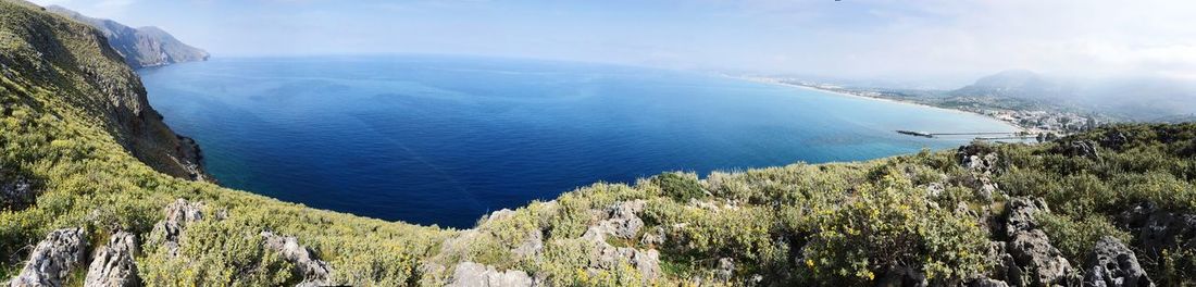 High angle view of sea and mountains against sky