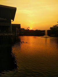 Scenic view of silhouette buildings against sky during sunset