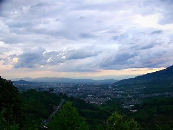 Cityscape against cloudy sky