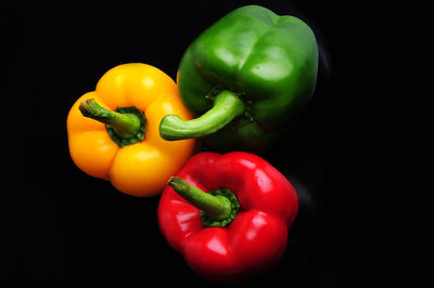 Close-up of bell peppers against black background