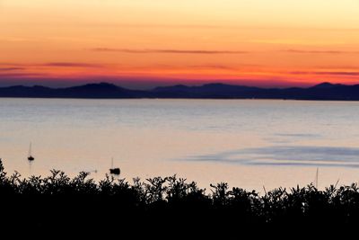 Scenic view of silhouette mountains against sky during sunset