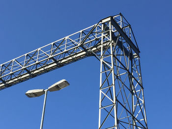 Low angle view of metallic structure against clear blue sky