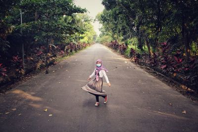 Full length of woman on road