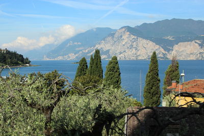 Scenic view of sea and mountains against sky