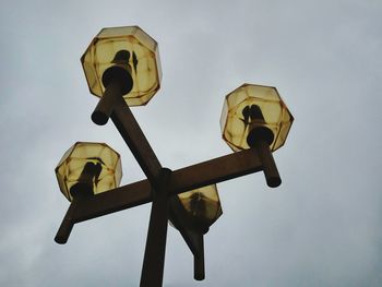 Low angle view of antique street light against sky