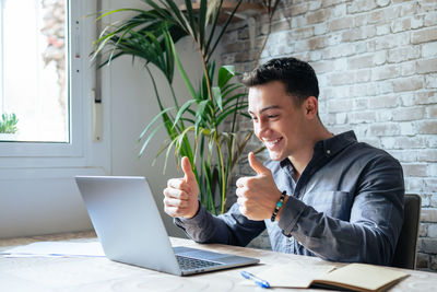Young man using laptop at office