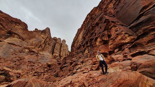 Full length of woman on rock formation against sky