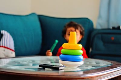 Close-up of boy sitting on table