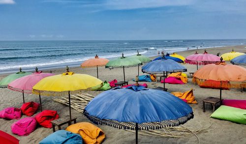 Umbrellas on beach against sky