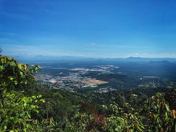 Scenic view of landscape against blue sky