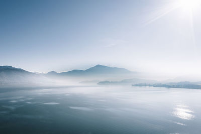 Scenic view of sea and mountains against sky