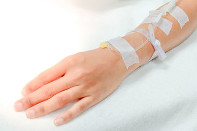 Close-up of hands over white background