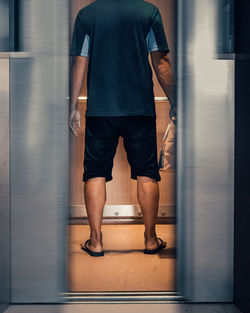 Low section of man standing on floor