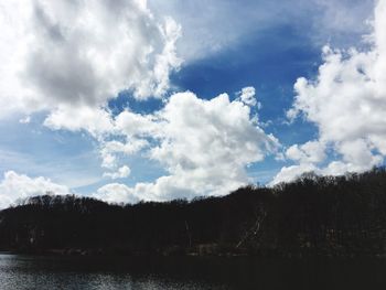 Scenic view of trees against blue sky