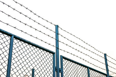 Low angle view of chainlink fence against clear sky