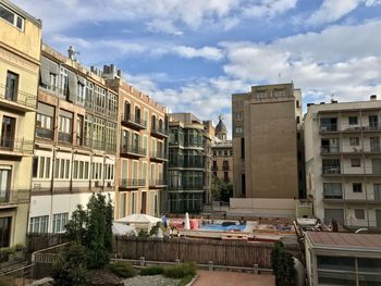Buildings in town against sky
