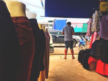 Rear view of people standing at market