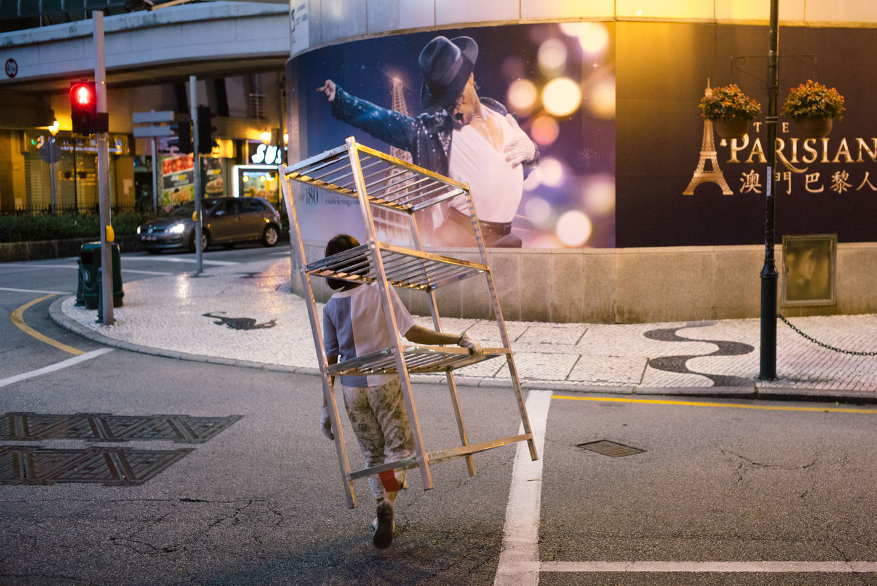 real people, street, one person, men, occupation, road, building exterior, outdoors, lifestyles, built structure, architecture, night, city, full length, working, people