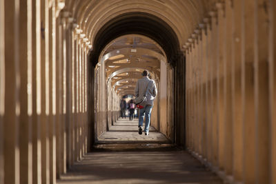 People walking in corridor of building