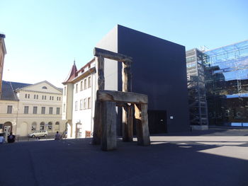 Buildings against clear blue sky