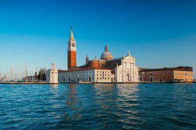 View of buildings against clear blue sky