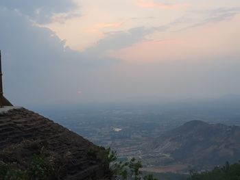 Scenic view of townscape against sky at sunset