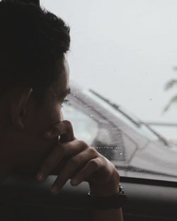 Close-up of man hand on airplane window