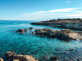 Cove with clear water, rocks and stones at the bottom