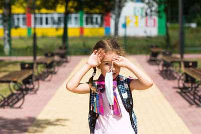 Portrait of girl standing on street